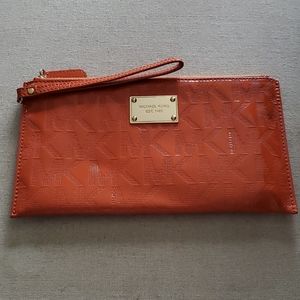 Michael kohrs orange clutch bag